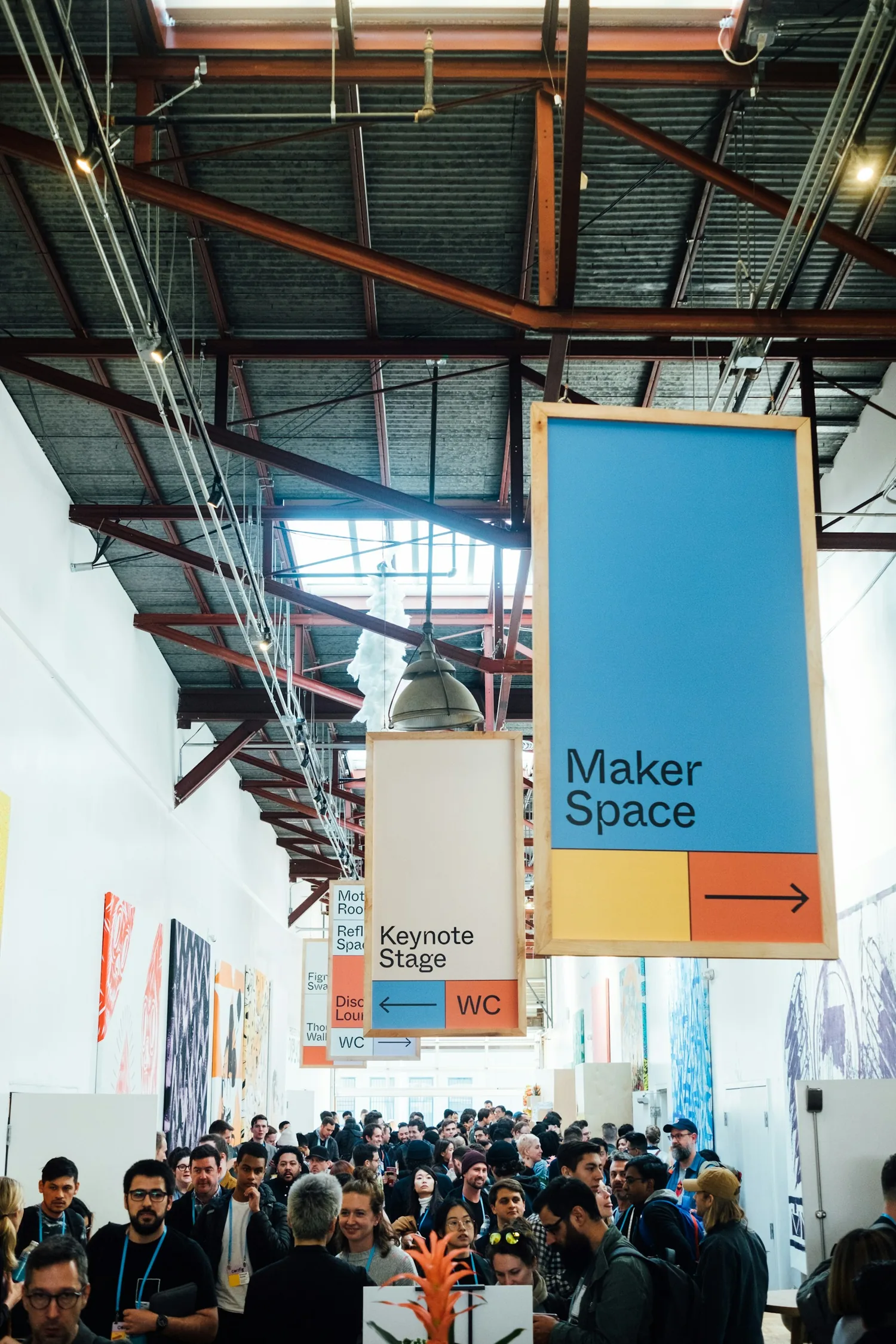 Creators gathering inside a busy maker space at a design conference