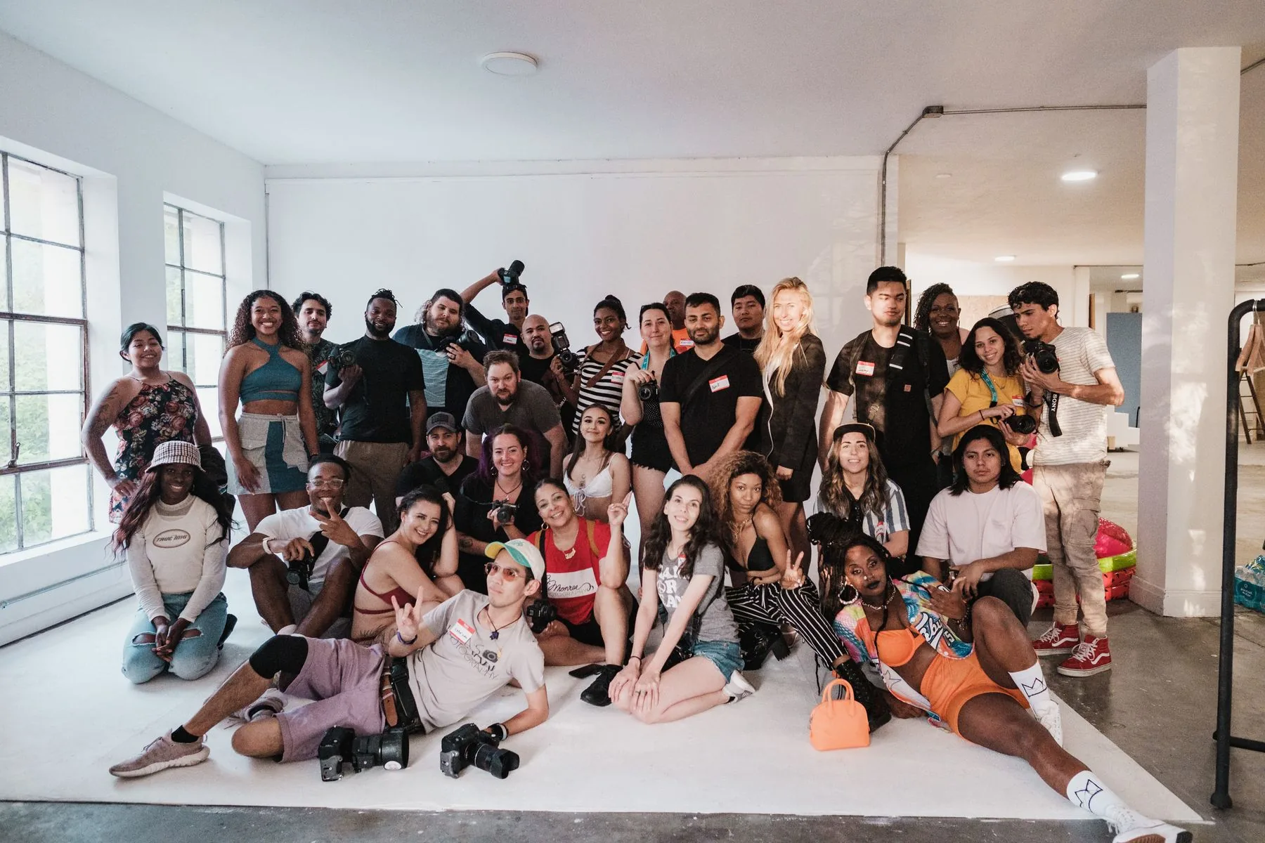 A diverse group of creators gathered with their cameras